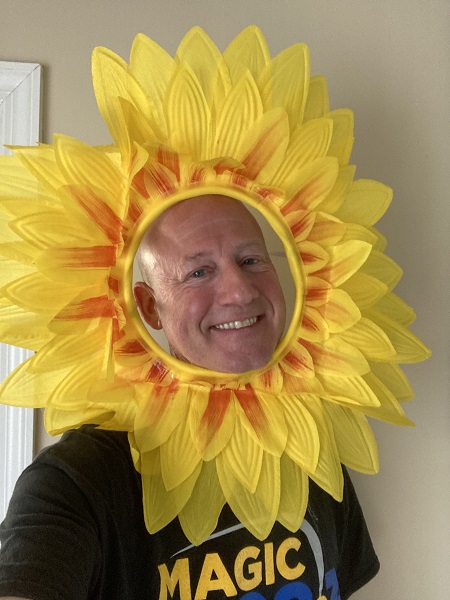Joel Katz wearing a sunflower around his head