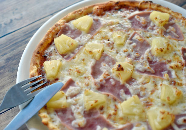 A Hawaiian (ham and pineapple) pizza pictured in in Garmisch-Partenkirchen, Germany, 10 June 2017. S. Panopoulos, who is credited with inventing the Hawaiian pizza died on 8 June 2017, aged 83, according to Candaian media reports. Photo: Angelika Warmuth/dpa (Photo by Angelika Warmuth/picture alliance via Getty Images)
