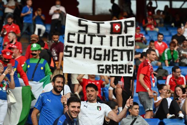 Italian supporters hold a banner reading "Stop cutting spaghetti grazie" ahead of the during the World Cup 2022 qualifier football match between Switzerland and Italy, on September 5, 2021 at St Jakob-Park stadium in Basel. (Photo by Fabrice COFFRINI / AFP) (Photo by FABRICE COFFRINI/AFP via Getty Images)